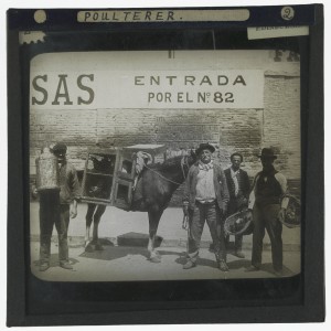 'Poulterer, Buenos Aires [Argentina]'. Photograph of a poulterer standing with his horse carrying cages of poultry on a street in Buenos Aires, Argentina in the early 20th century. Next to him is a man carrying a milk cannister, a man carrying two baskets of fruit and another man smoking a cigarette. http://images.is.ed.ac.uk/luna/servlet/s/19g4jx